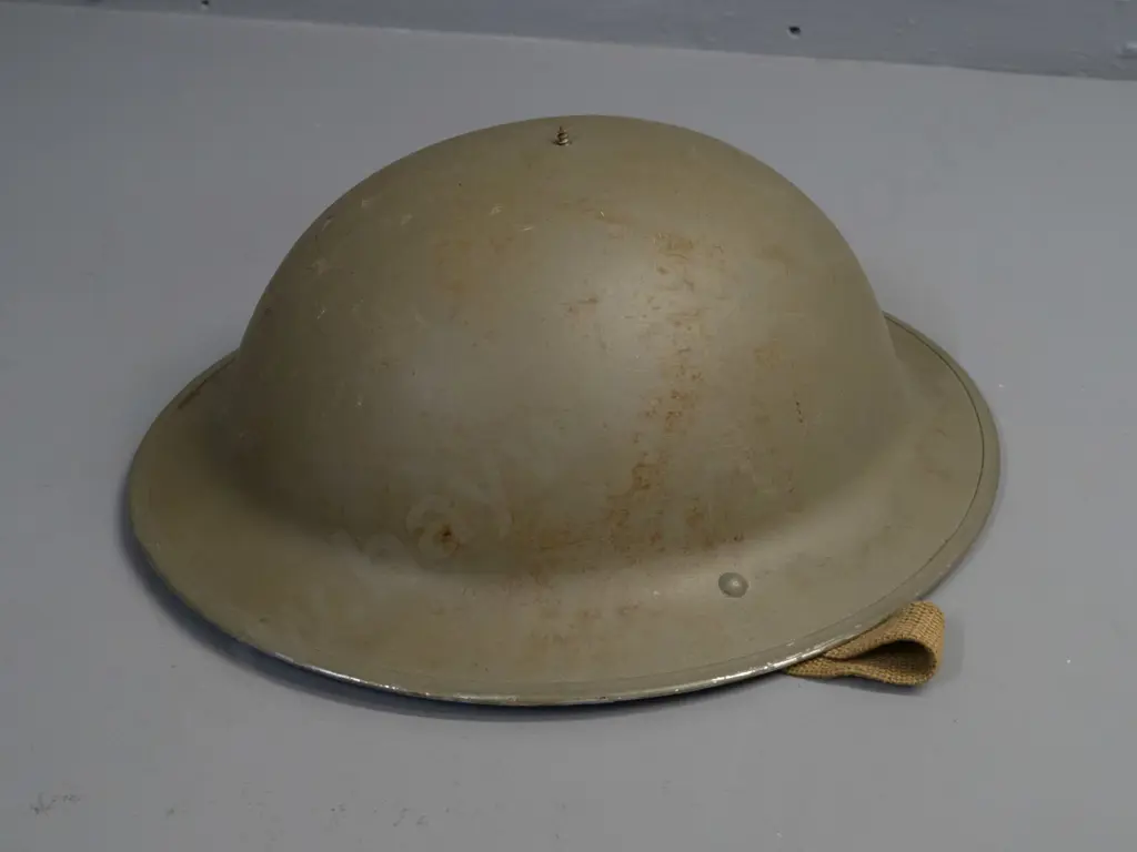 WWII-era British army helmet with suspension liner, webbing strap, missing top dome - overall age wear Image 1++