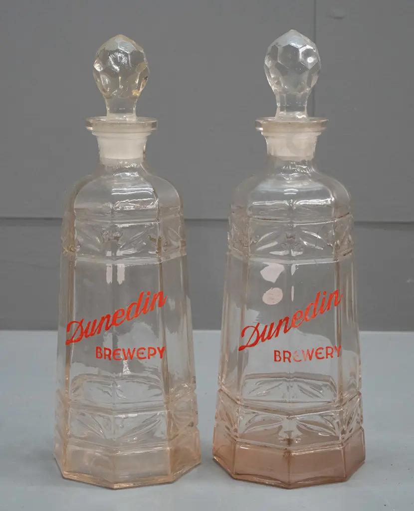 pair of clear glass stoppered decanters marked "Dunedin Brewery" - one with staining inside, minor wear to lettering on Image 1++