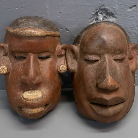 2 carved wood Makonde masks from Tanzania - one has chip to bottom H-220 W-150
