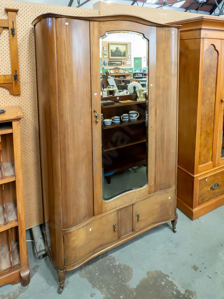 art deco mahogany serpentine fronted wardrobe w/ bevelled edge shaped mirror, brass drop handles to 2 doors, hanging Image 1++
