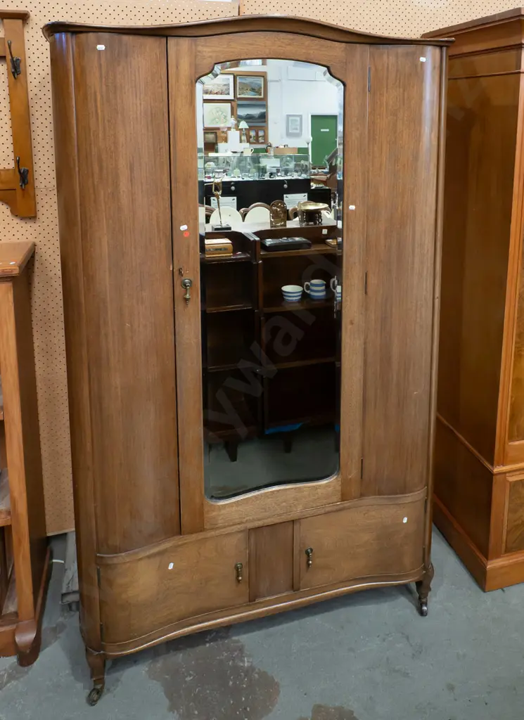 art deco mahogany serpentine fronted wardrobe w/ bevelled edge shaped mirror, brass drop handles to 2 doors, hanging Image 1++