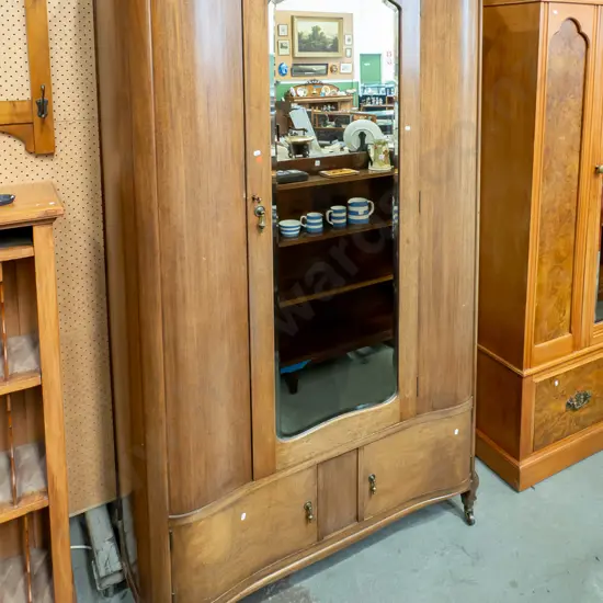 art deco mahogany serpentine fronted wardrobe w/ bevelled edge shaped mirror, brass drop handles to 2 doors, hanging