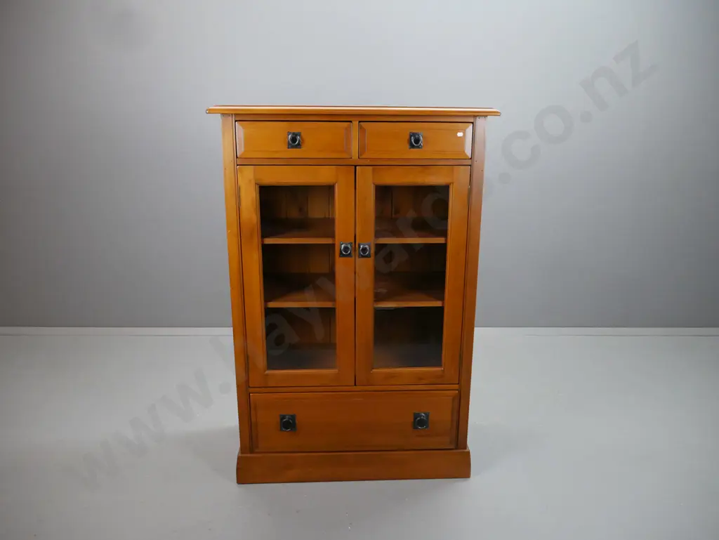 rimu cupboard with 2 drawers over 2 glazed doors, 2 adjustable inner shelves, large bottom drawer, metal ring handles. Image 1++