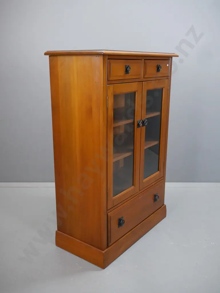 rimu cupboard with 2 drawers over 2 glazed doors, 2 adjustable inner shelves, large bottom drawer, metal ring handles. Image 1++