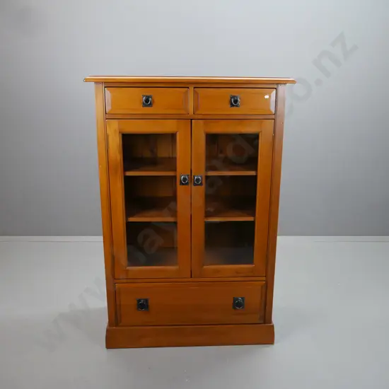 rimu cupboard with 2 drawers over 2 glazed doors, 2 adjustable inner shelves, large bottom drawer, metal ring handles.