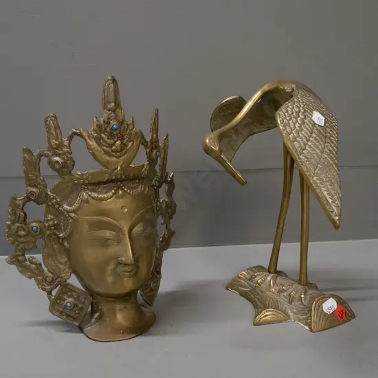2 cast brass pieces - crane and a Thai-style head, missing a few blue stone or glass inserts, both approx. H-240
