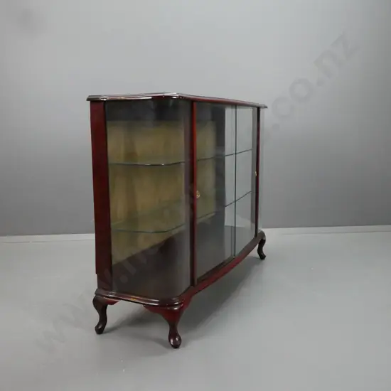 mid-century mahogany cab-leg display cabinet with bowed glass ends, 2 glass sliding doors and 2 fixed glass shelves,