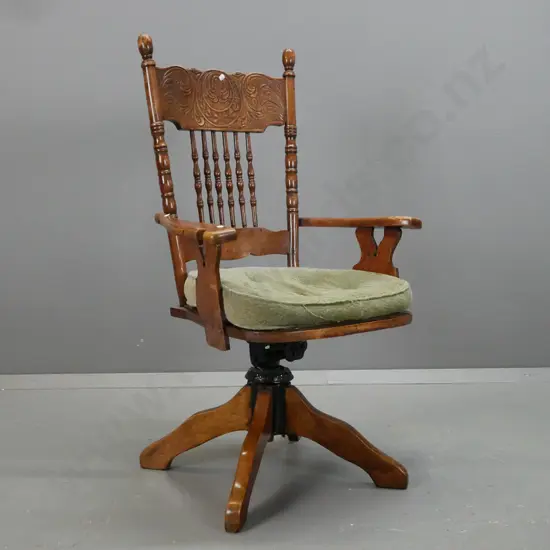 Edwardian beech desk chair with press-carved and turned spindle back, tilting & rotating base, pierced ply seat marked