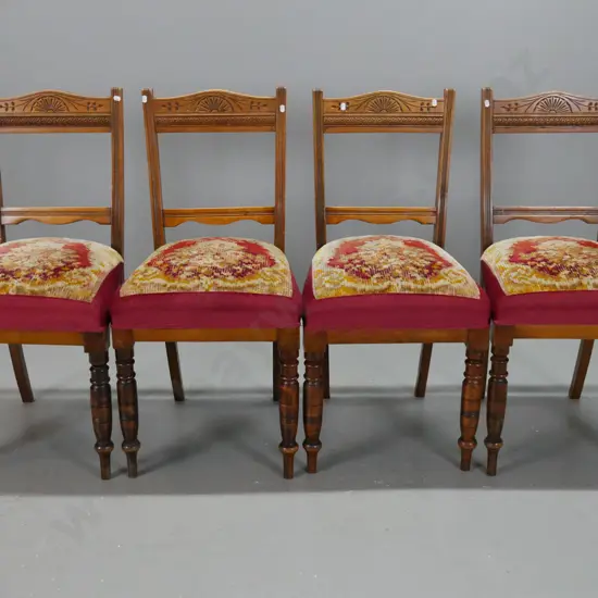 4 Edwardian beech dining chairs with turned front legs, carved back rail, reeded back supports, tapestry seats with