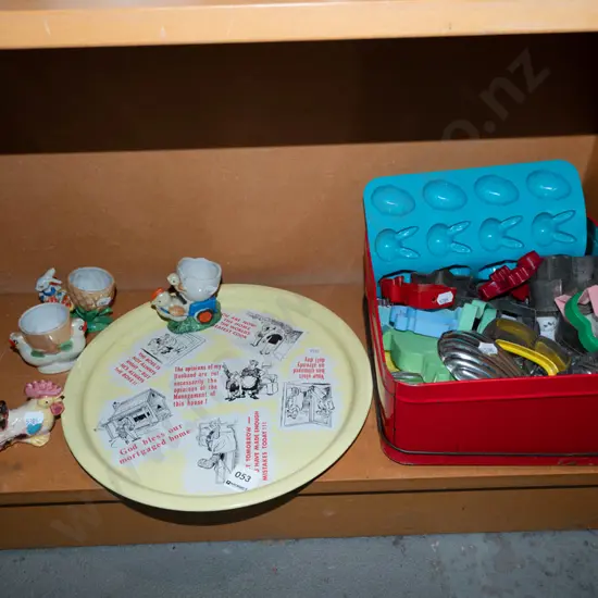 metal tray, novelty eggcups, cake tin with cookie cutters and moulds
