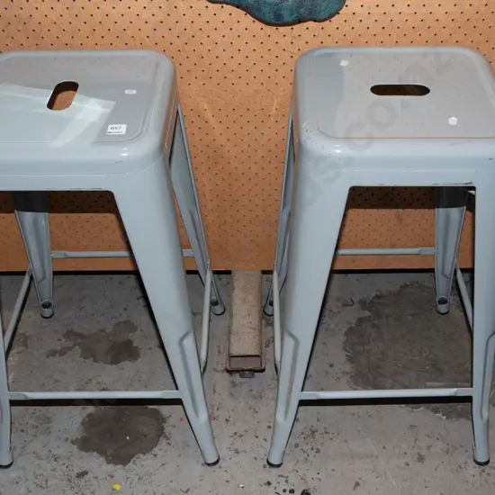 2 grey metal stools