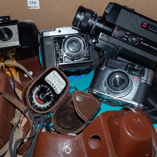 box; Zeiss Super Ikonta and other vintage film cameras, Canon 8mm cine camera, light meter etc