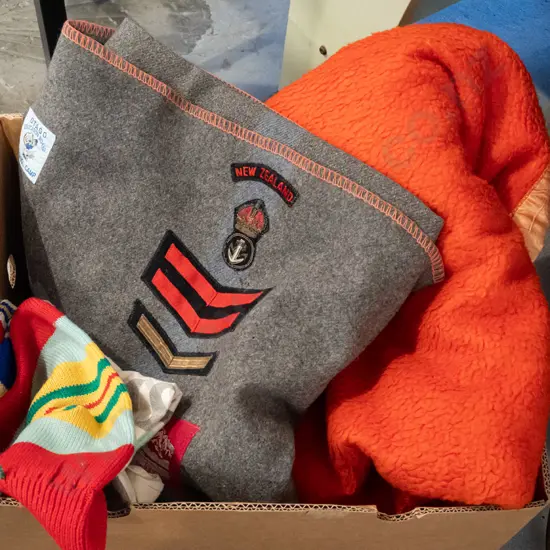 box; orange blanket, grey woollen blanket with pennants and badges etc