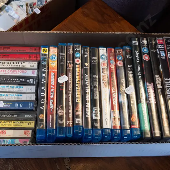 box of tape cassettes and DVDs
