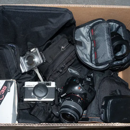 box; Sony digital camera, Konica 35mm camera, small Canon digital camera etc