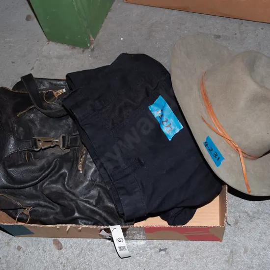 box; leather backpack, work trousers, stockmens hat