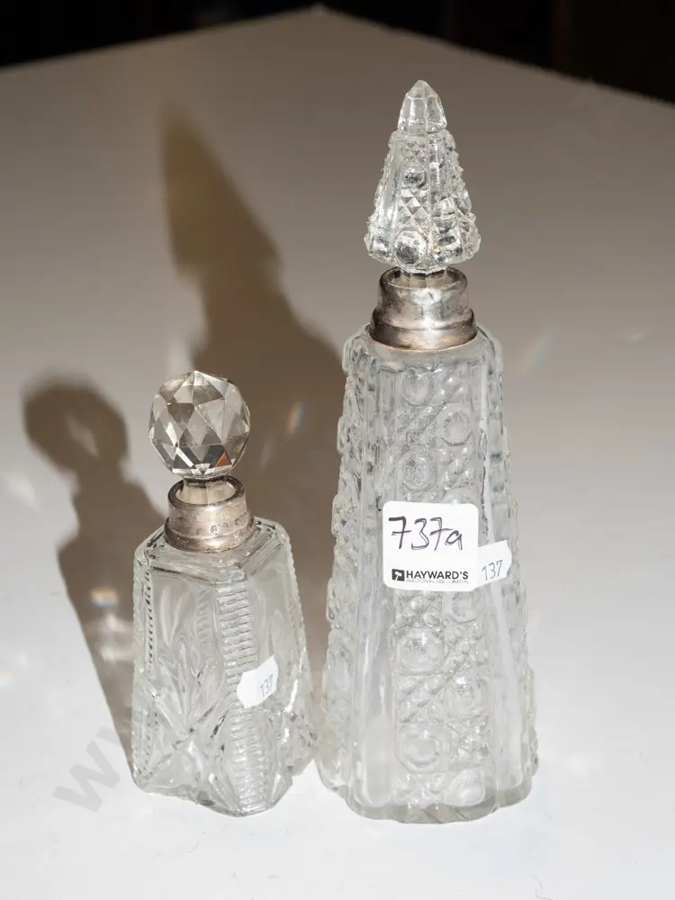 2x cut glass stoppered bottles - both have sterling silver rims - 1 stopper is mismatched to bottle, other has chips Image 1++