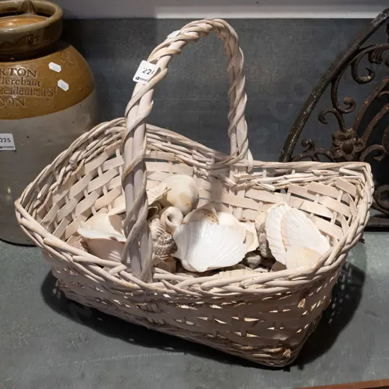white painted cane basket and seashells
