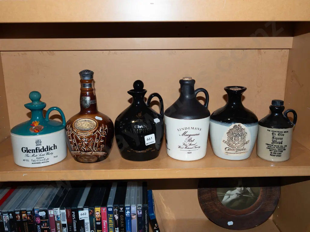 shelf of whisky bottles/jugs Image 1++