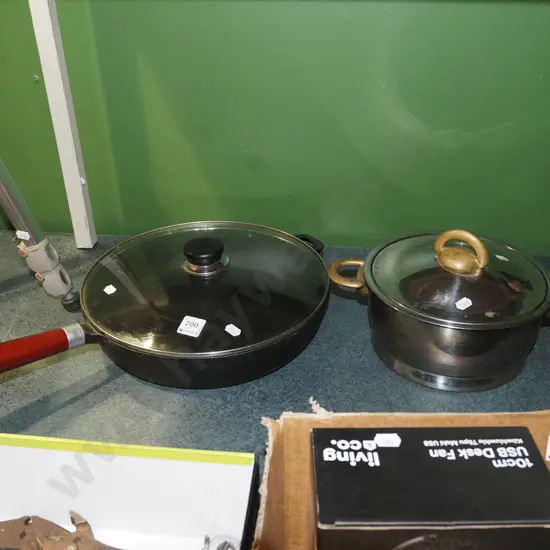 cast iron lidded frying pan, stainless steel and brass pot