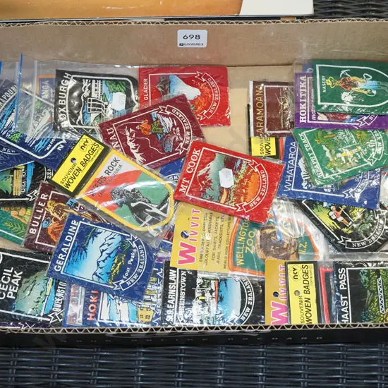 box of NZ tourist badges and emblems