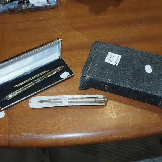 small bible, mechanical pencil and pen