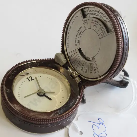Small travel clock with perpetual calendar