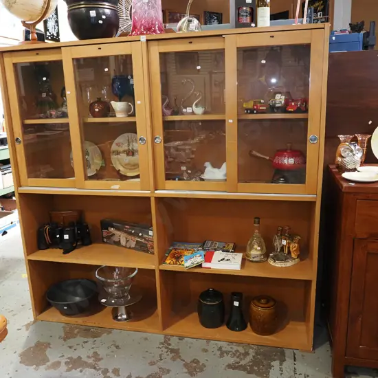 solid rimu wall unit with 4 sliding glass display doors and lower shelving