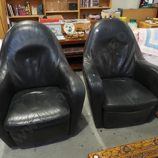 pair of retro black leather upholstered swivel rocking chairs