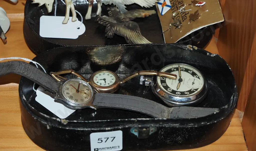 small lidded box; carved bone brooches, watches, badges Image 1++
