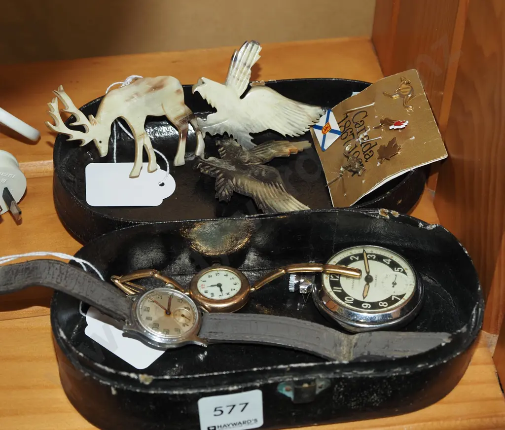 small lidded box; carved bone brooches, watches, badges Image 1++