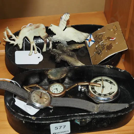 small lidded box; carved bone brooches, watches, badges