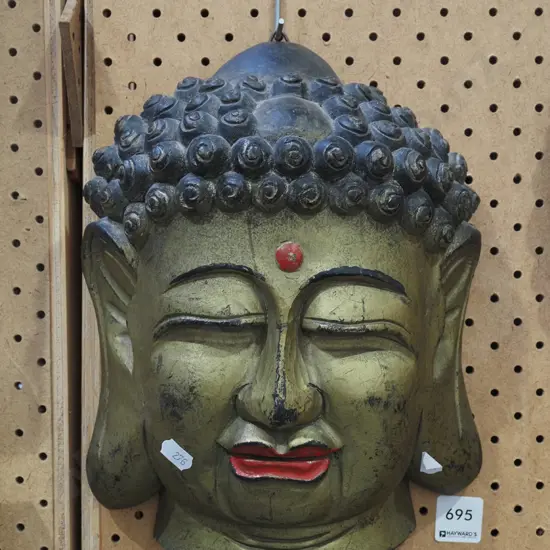 carved wooden wall buddha