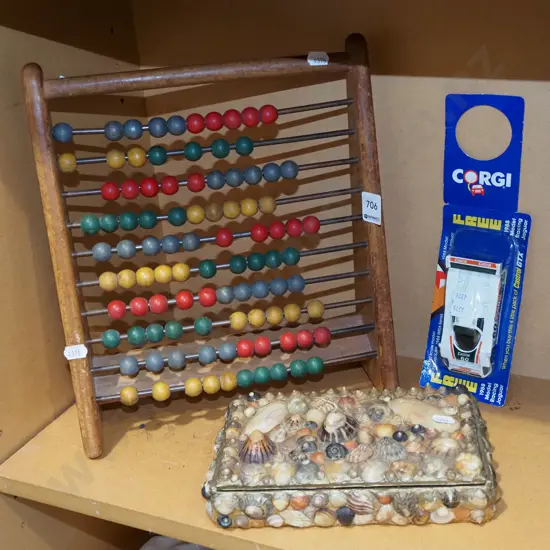 abacus, model vehicle, seashell cigar box