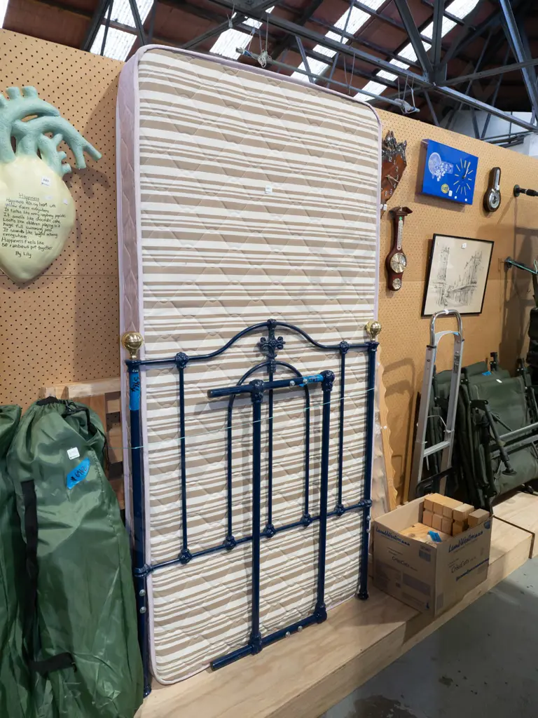 single slat bed base and mattress with blue metal and brass ends Image 1++