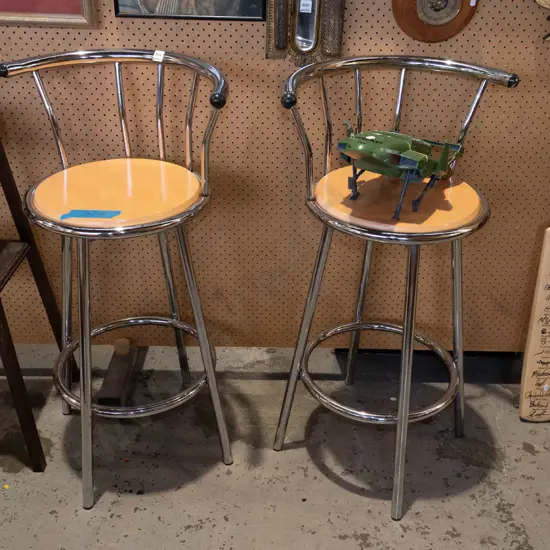 pair of chrome and wood bar stools