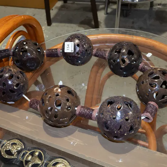 studio  pottery balls and cylinders on circular rope