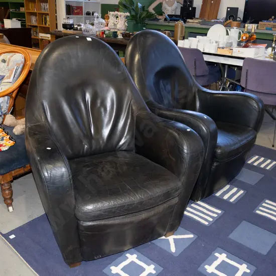pair of black leather armchairs - 1 swivels, 1 does not