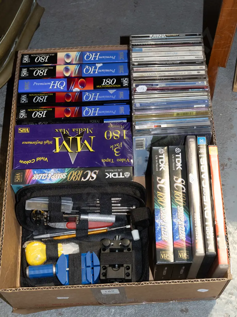 box; unused VHS tapes, DVDs, CDs, watchmaker's repair kit Image 1++