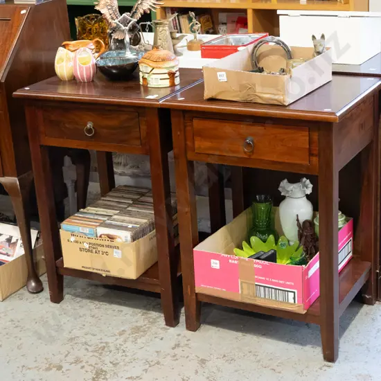 pair of dark stained bedside cabinets