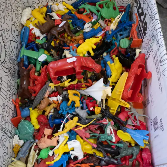 box of plastic toy animals etc