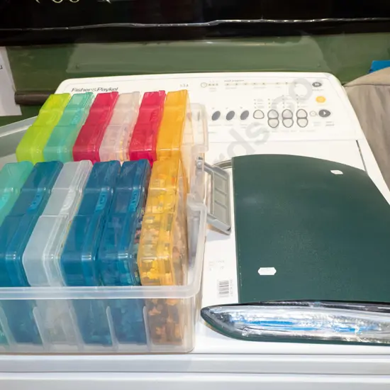 plastic organiser of miniature Lego type pieces, instruction folder