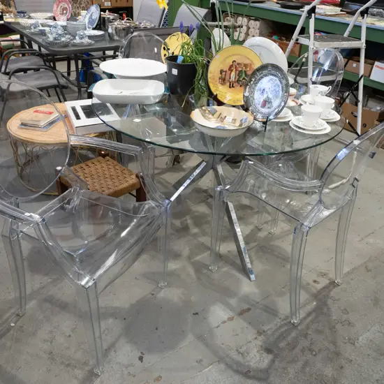 chrome based glass top circular dining table with 4x Kartell Ghost Louis style clear polycarbonate chairs H750 Diam1140
