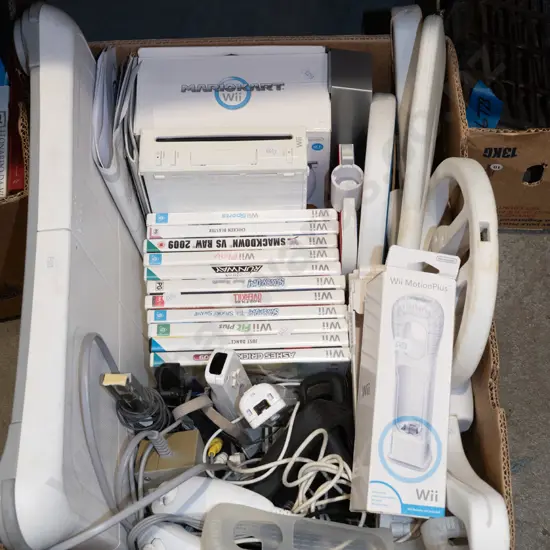box of Nintendo Wii with games and acessories