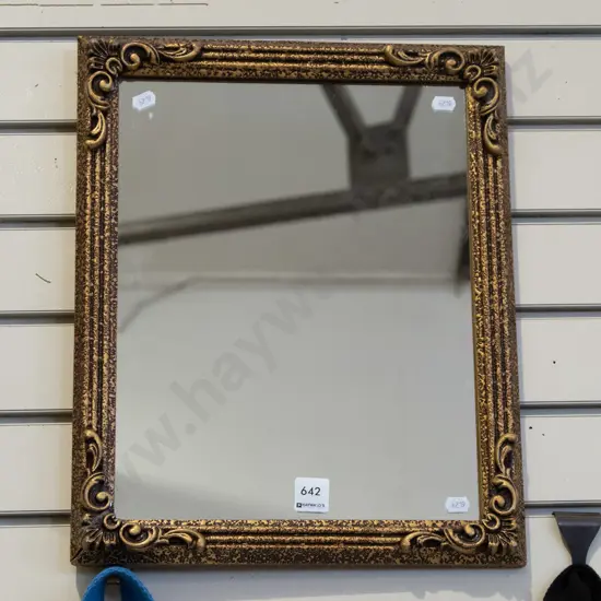 small gilt-framed wall mirror