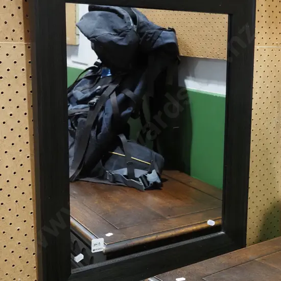 dark faux wood framed wall mirror