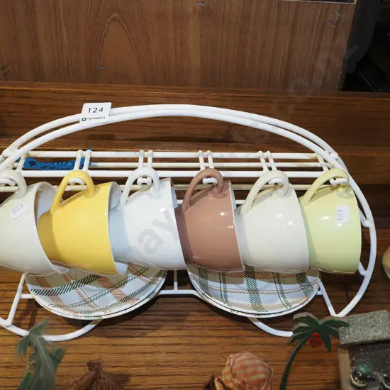 6x Crown Lynn cups, 4x saucers and plastic stand
