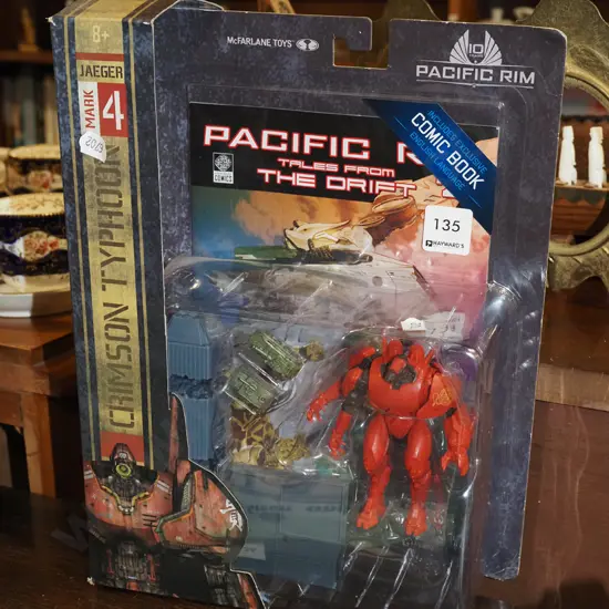 carded Pacific Rim action figurine with comic book