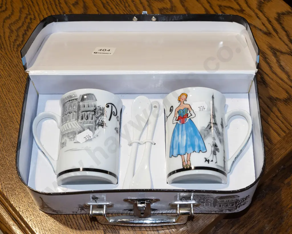 2x coffee cups in small cardboard suitcase Image 1++