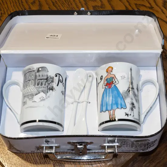 2x coffee cups in small cardboard suitcase
